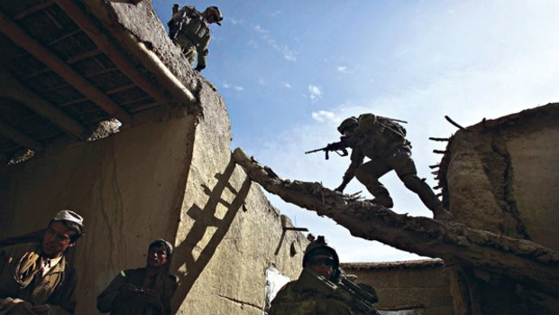 Taking steps to end insurgency ... Australian and Afghanistan troops search houses in Chora, Afghanistan, for hidden weapons, explosives and Taliban fighters.