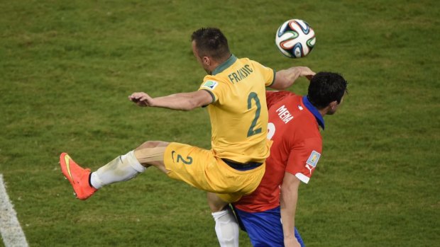 Australia's defender Ivan Franjic tears his hamstring leaping for the ball against Chile.