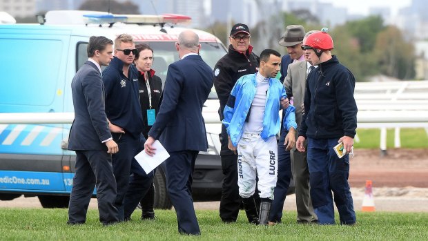 Lucky escape:  Joao Moreira hobbles off the track after a horror fall.