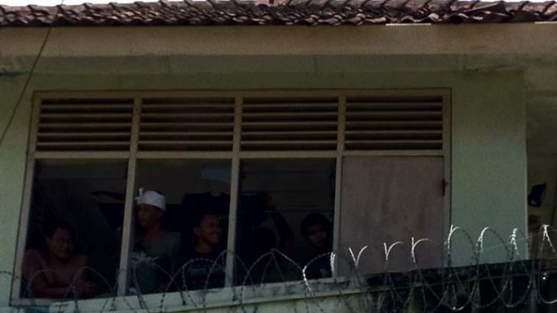 Prisoners are still in control of Kerobokan prison with some pictured here in a guard tower.