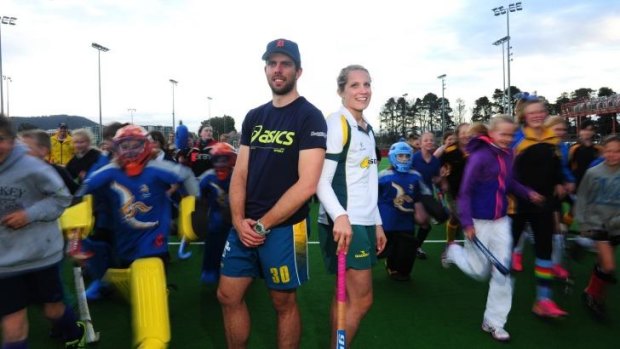 Kookaburras goal keeper Andrew Charter and Hockeyroos player Edwina Bone with kids for a coaching clinic at the National Hockey Centre in Lyneham.