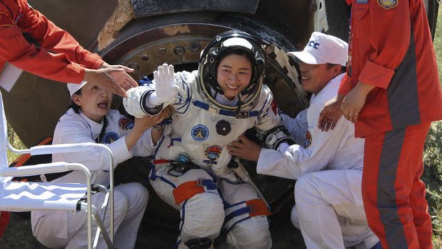 The final frontier: China's first female astronaut Liu Yang leaves the re-entry capsule of a Shenzhou-9 spacecraft in  Inner Mongolia in June last year.