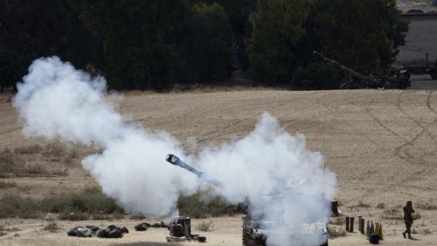 An Israeli mobile artillery unit fires towards Gaza.