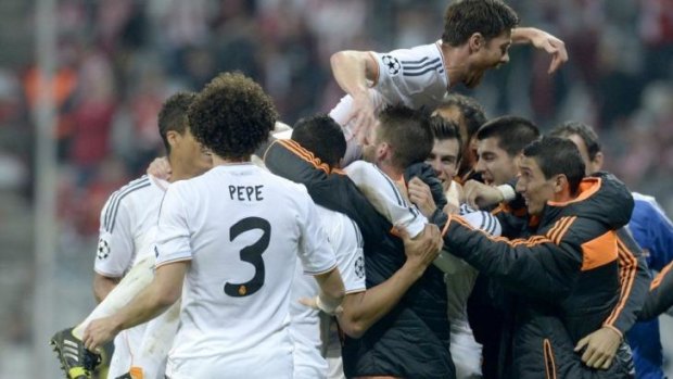 Xabi Alonso (top) celebrates the win with his Real Madrid teammates.