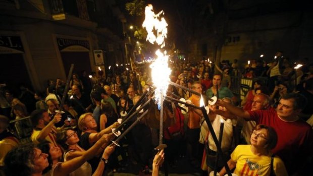 Catching fire: Marchers prepare for Catalonia's National Day in central Barcelona.