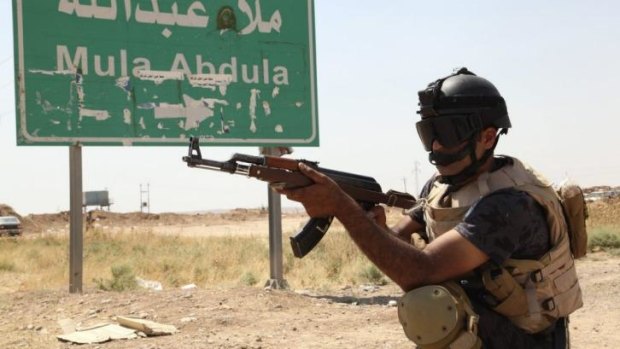 A member of the Kurdish security forces patrols the outskirts of Kirkuk.
