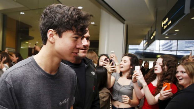 5 Seconds of Summer's Calum Hood meets the crowd at Sydney airport on April 28, 2014.