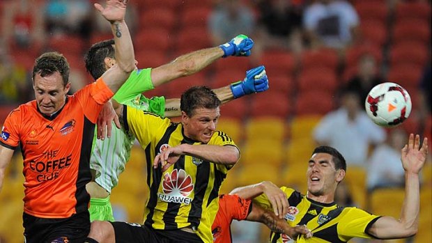 Full stretch: Roar goalkeeper Michael Theo punches the ball clear of the danger zone against Wellington.