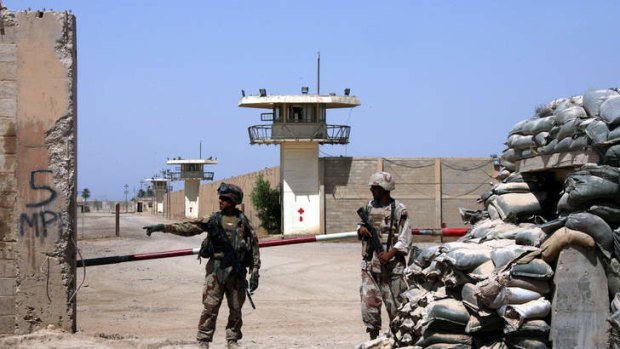 Iraqi army soldiers stand guard at the Abu Ghraib prison on the outskirts of Baghdad, Iraq in 2006.