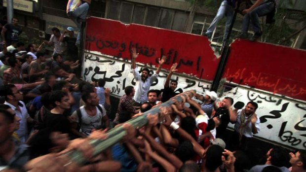 Wall brawl ... Egyptians attack the Israeli embassy.