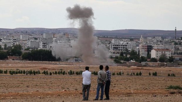 Smoke rises from a residential area near Syrian border town of Kobani during an attack by Islamic State fighters.