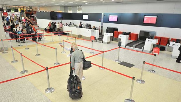 The Qantas check-in is close to deserted at Melbourne Airport.
