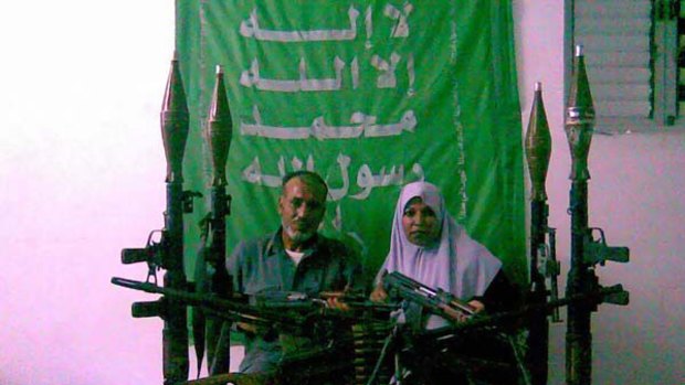 The parents of Munir Warshara posing with the weapons their son smuggled into the Gaza Strip for Hamas. <i>Picture: Jason Socrates Koutsoukis</i>