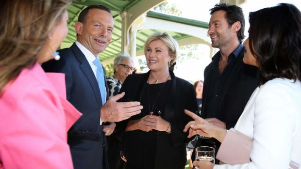 Prime Minister Tony Abbott with actors Deborah-Lee Furness and Hugh Jackman after announcing his support for making overseas adoption easier for Australian couples. An expert advisory group on adoptions was recently disbanded by the government.