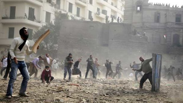 Missiles and firebombs are thrown as running battles rage between the two sides in Cairo's central Tahrir Square.