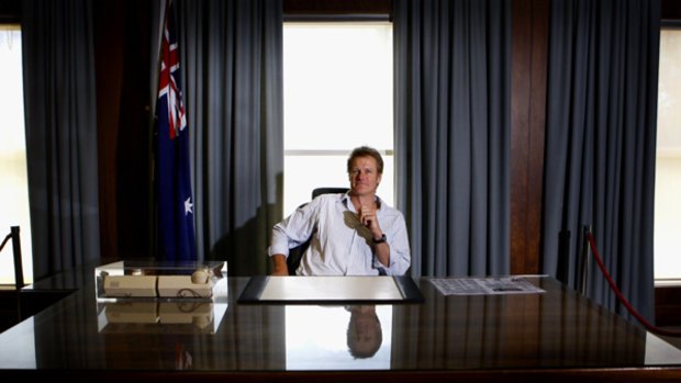 William McInnes, Chairman of the Old Parliament House Advisory Council sits at the Prime Minister's desk last occupied by Bob Hawke.