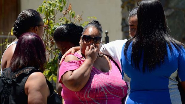 A hard life, a sad end ... Rodney King’s daughter Candice is comforted by family.
