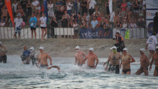 Swimmers hit the water at Cottesloe Beach.