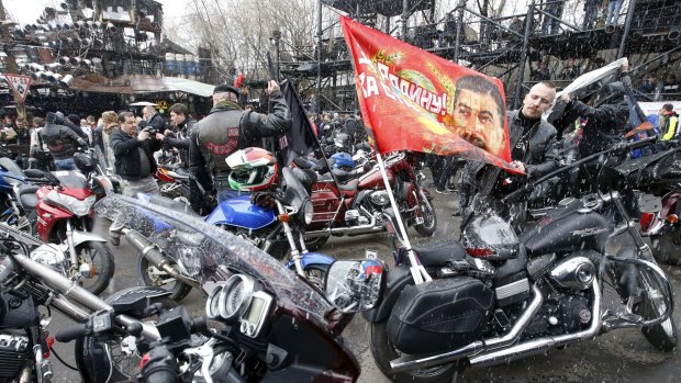 A man adjusts a flag before a farewell ceremony to see off bikers commemorating the 70th anniversary of the victory over Nazi Germany in World War II, at a bike centre in Moscow.