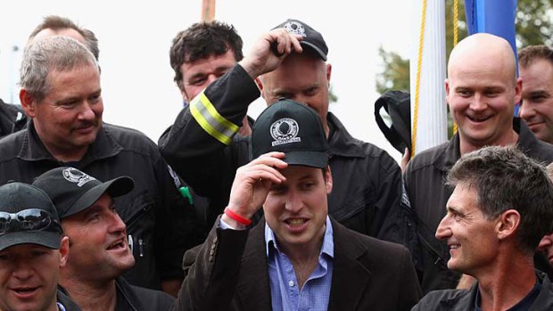 Hats off ... Prince William shares a joke with members of the Urban Search and Rescue team during his tour through Christchurch.