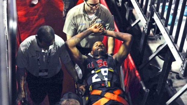 Stretchered off: Paul George is rushed to hospital after his horrific leg injury.