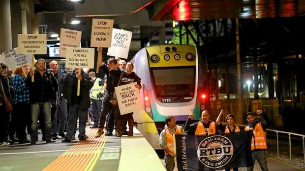 Rail, tram and bus union workers protest at Southern Cross station.