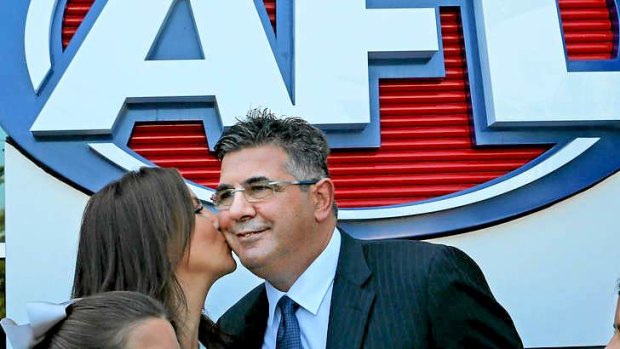 AFL chief executive Andrew Demetriou is kissed by his wife Symone during an AFL press conference.