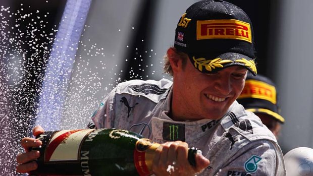 Nico Rosberg of Germany and Mercedes GP celebrates on the podium after winning the British Formula One Grand Prix at Silverstone.