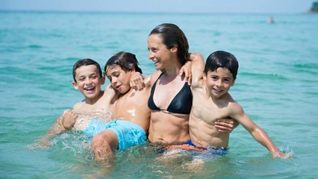 Close family: Sam Bloom swimming with her three sons, Rueben, Noah and Oliver.