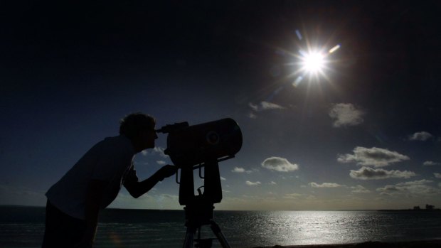 Amateur astronomer Rob Loney sets his telescope in the sandhills near Ceduna in preparation for a total eclipse of the sun in 2002.