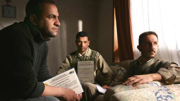 Iraqi interpreters Sabbah, Mohammed, and Zeki with their certifi cates of appreciation for translation services in the Iraq war.