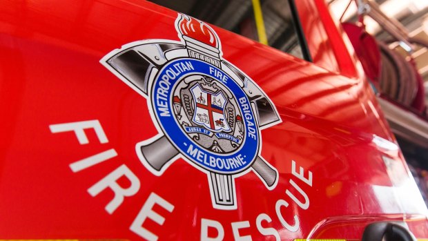 Firefighters were forced to smashed the window of a parked car to rescue a child locked inside in Melbourne's north.  