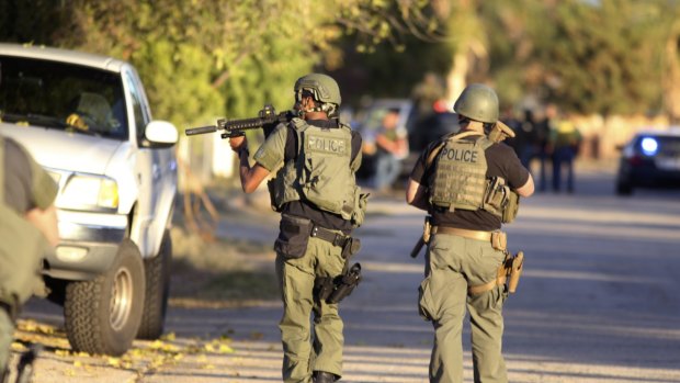 Police at the scene of a shootout about a mile from the site in San Bernardino where gunmen left at least 14 dead.