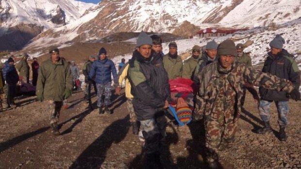 An injured hiker is assisted by Nepal Army soldiers in Manang District, along the Annapurna Circuit hiking trail.