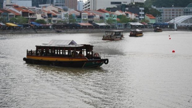 Boat Quay offers ample room to sit and watch the world go by.