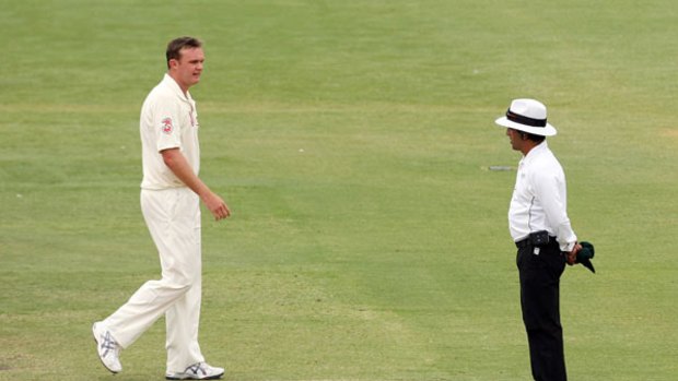 Doug Bollinger of Australia shows his frustration to umpire Asad Rauf after an unsuccessful appeal.