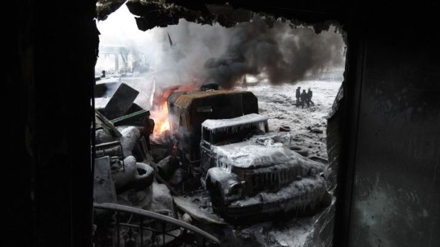 A burnt truck is seen at the site of clashes protesters and riot police in Kiev.