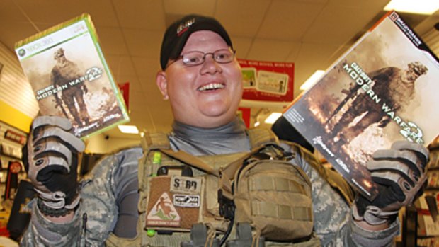 Erik Cota walks out of a shop in California shortly after <i>Call of Duty Modern Warfare 2</i> went on sale at midnight.