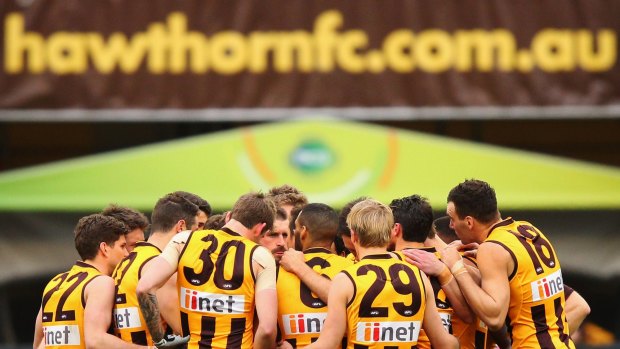 MELBOURNE, AUSTRALIA - AUGUST 13: Hawks players huddle during the round 21 AFL match between the Hawthorn Hawks and the North Melbourne Kangaroos at Melbourne Cricket Ground on August 13, 2016 in Melbourne, Australia. (Photo by Michael Dodge/Getty Images)