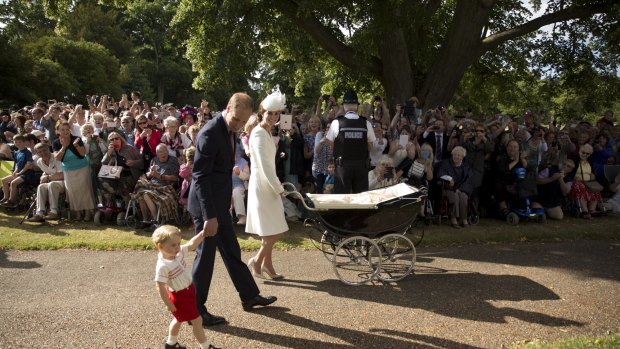 Well-wishers look on as the Cambridges arrive for Princess Charlotte's christening.