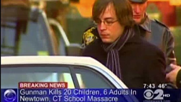 Incorrectly targeted ... Ryan Lanza, the 24-year-old brother of Sandy Hook Elementary School shooter Adam Lanza, is escorted by police.