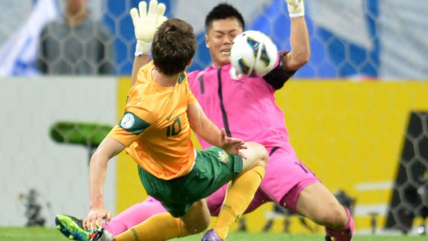 Hands up: Japan's goalkeeper Eiji Kawashima foils Robbie Kruse's shot during the 1-1 draw.