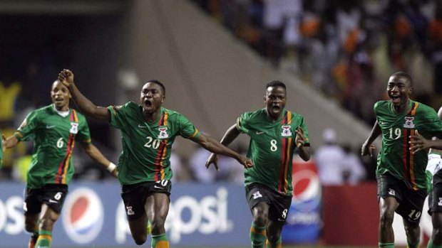Match winners ... the Zambia team run to celebrate with Stophira Sunzu after his penalty secured victory in the final of the African Cup of Nations.