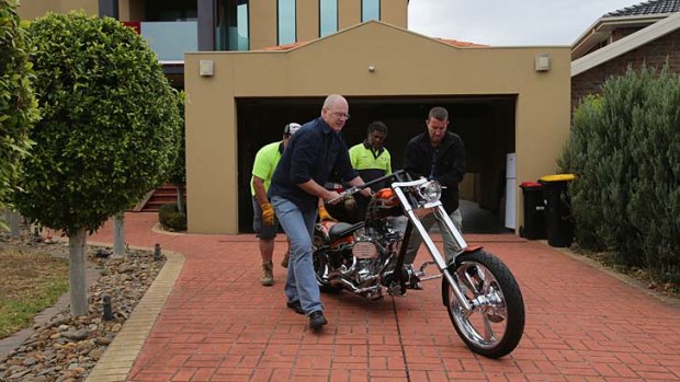 A Harley-Davidson is wheeled away after the police raid.