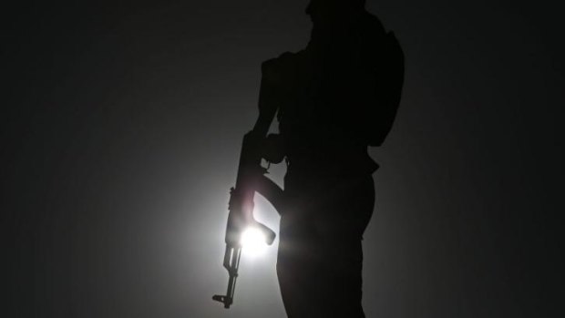 An Afghan police officer stands guard during a campaign rally in the Paghman district of Kabul, Afghanistan, on Monday.