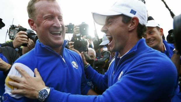 Team Europe golfer Jamie Donaldson celebrates with teammate Rory McIlroy.