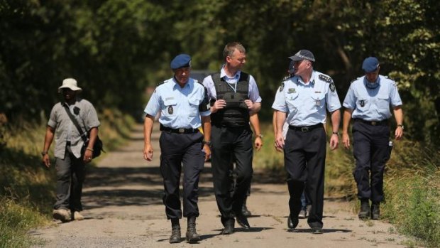 Australian Federal Police officer Brian McDonald (second from right) talks with his Dutch counterpart.