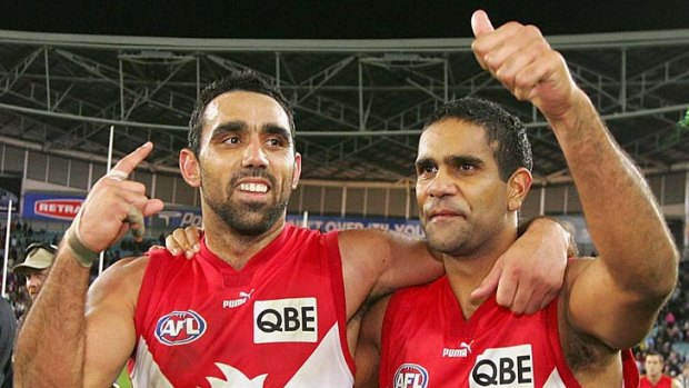 Adam Goodes and Michael O'Loughlin of the Swans celebrate victory against the Collingwood Magpies .
