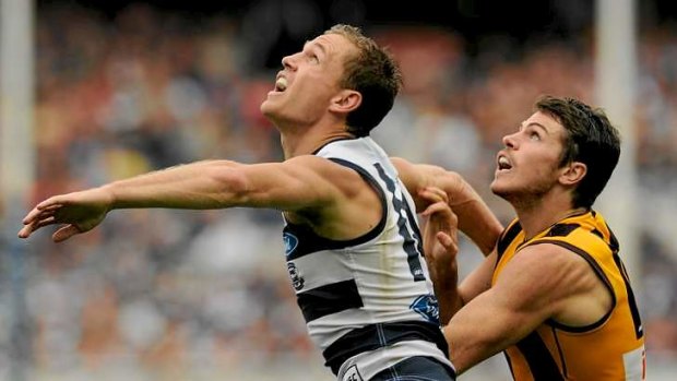 Joel Selwood battles with Hawthorn's Isaac Smith at the MCG on Monday.