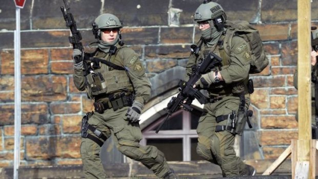A Royal Canadian Mounted Police intervention team responds to the shooting at the Parliament building in Ottawa.
